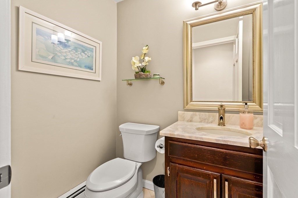 136 Leslie Road Rowley, MA 01969 - Photo 11 of 28 a bathroom with a toilet a sink and mirror