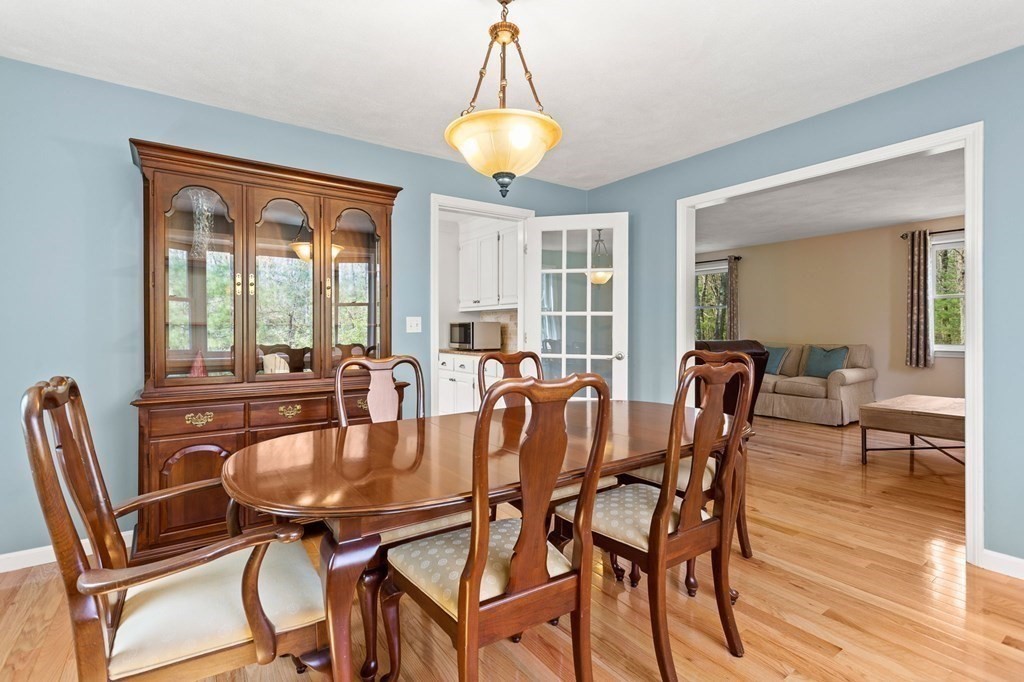 136 Leslie Road Rowley, MA 01969 - Photo 8 of 28 a dining room with furniture a chandelier and wooden floor