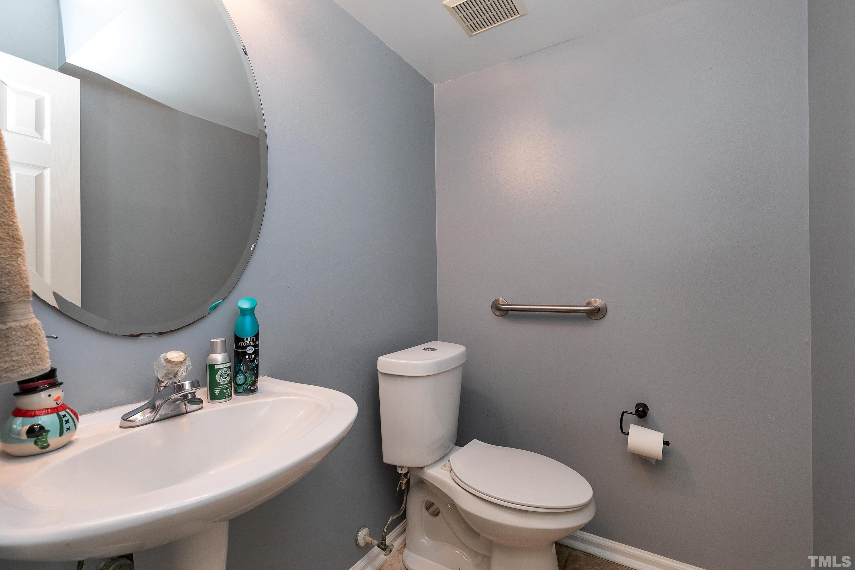 4416 Windstorm Way Raleigh, NC 27616 - Photo 18 of 31 a bathroom with a sink a toilet and a mirror