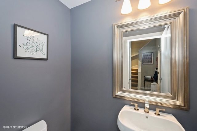 650 West Fulton Street, Unit B Chicago, IL 60661 - Photo 13 of 34 a bathroom with a sink mirror and toilet