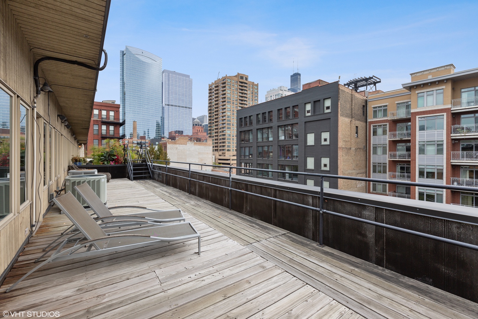 650 West Fulton Street, Unit B Chicago, IL 60661 - Photo 24 of 34 a view of a balcony with two chairs and a wooden floor