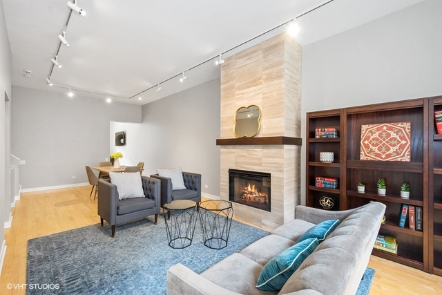 650 West Fulton Street, Unit B Chicago, IL 60661 - Photo 4 of 34 a living room with furniture a fireplace and a flat screen tv