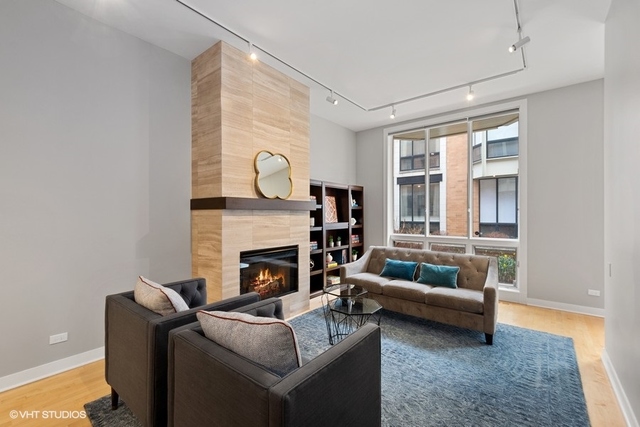 650 West Fulton Street, Unit B Chicago, IL 60661 - Photo 5 of 34 a living room with furniture and a fireplace