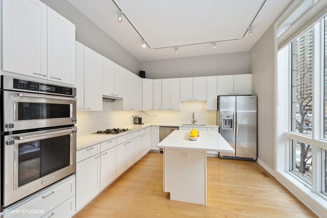 650 West Fulton Street, Unit B Chicago, IL 60661 - Photo 7 of 34 a kitchen with stainless steel appliances a stove a microwave and a refrigerator