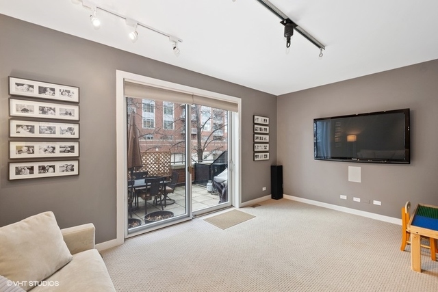 650 West Fulton Street, Unit B Chicago, IL 60661 - Photo 10 of 34 a living room with furniture and a flat screen tv