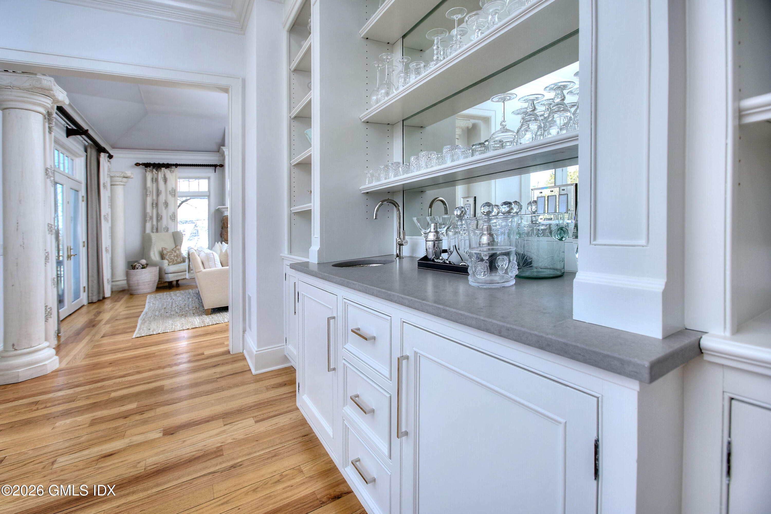 3 Shorehaven Road Norwalk, CT 06855 - Photo 15 of 40 a hallway with white cabinets and wooden floor