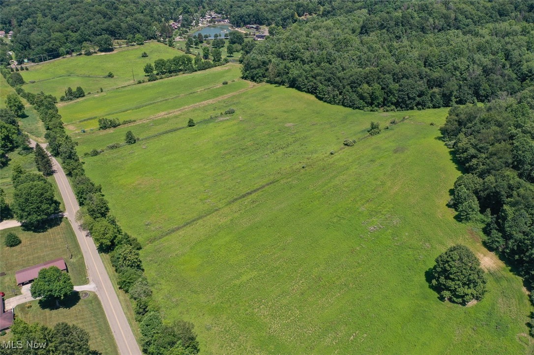 1728 Tall Timber Road Northeast New Philadelphia, OH 44663 - Photo 31 of 39 Aerial view of property and surrounding area featuring a forest