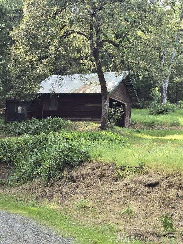 15305 Lake Arthur Road Auburn, CA 95602 - Photo 4 of 11 a view of a house with a yard and large trees