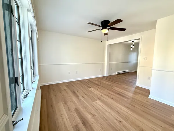 a view of empty room with wooden floor