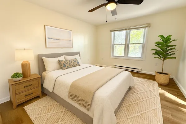 a bedroom with a bed and a potted plant