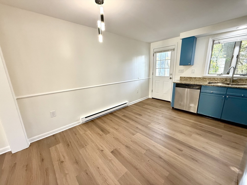 9 Olga Avenue, Unit 9 Worcester, MA 01605 - Photo 7 of 24 a view of a kitchen with a sink and wooden floor