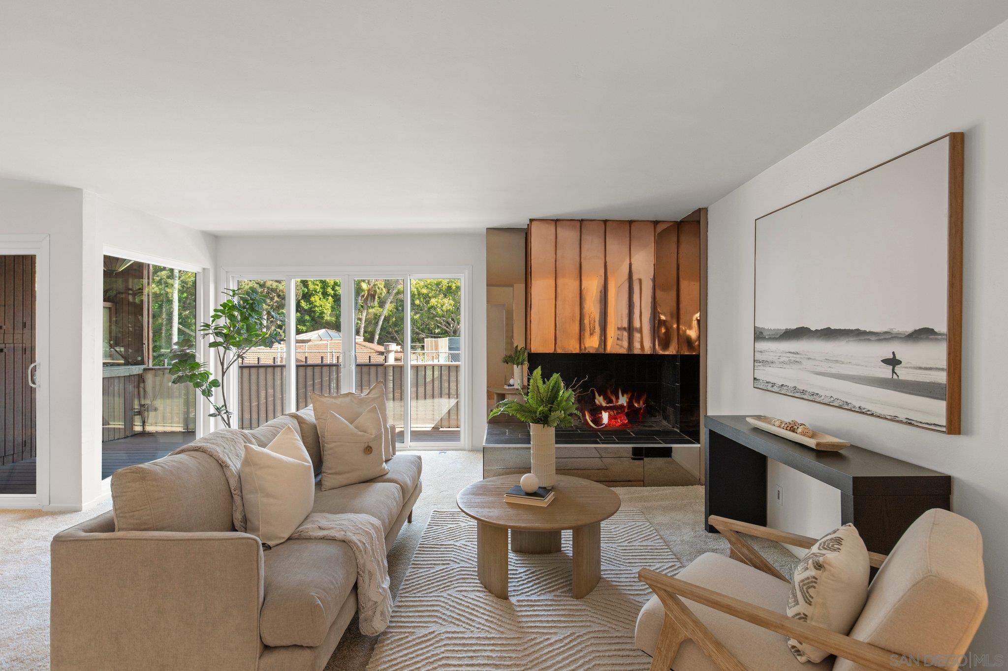 2610 Torrey Pines Road, Unit D25 La Jolla, CA 92037 - Photo 1 of 26 a living room with furniture a fireplace and a large window