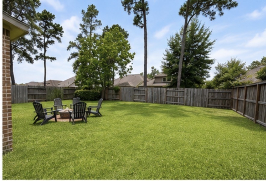 16863 Big Reed Drive Humble, TX 77346 - Photo 12 of 12 Spacious backyard with lush green space, mature trees, and plenty of room for outdoor entertaining or play.