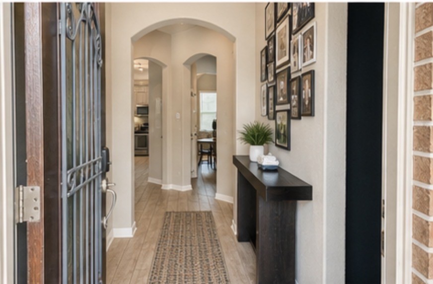 16863 Big Reed Drive Humble, TX 77346 - Photo 2 of 12 Welcoming entryway with elegant archways and stylish wood-look flooring.