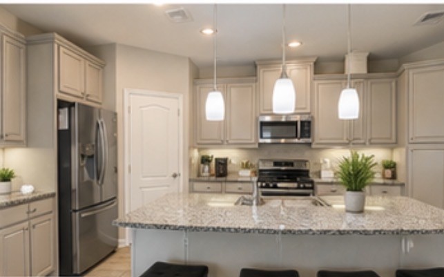 16863 Big Reed Drive Humble, TX 77346 - Photo 4 of 12 Spacious kitchen featuring granite countertops, stainless steel appliances, and ample cabinetry.