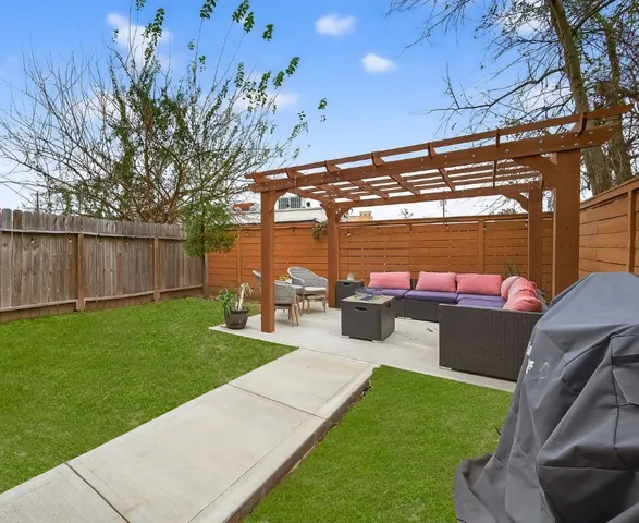 a view of a patio with couches chairs and a big yard