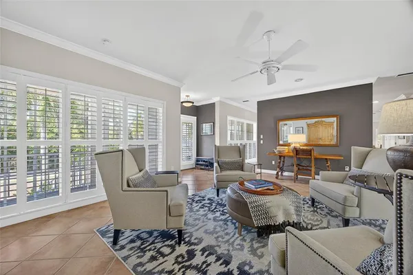 a view of a living room with hardwood floor and a ceiling fan