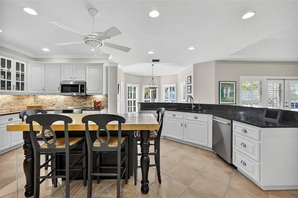 a kitchen with counter space cabinets and dining table