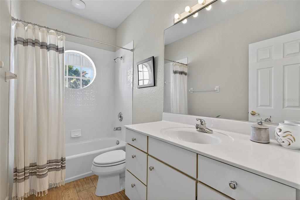 116 Dolly Street Punta Gorda, FL 33950 - Photo 40 of 60 a bathroom with a double vanity sink toilet mirror and shower