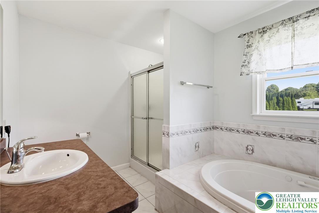 590 Fehr Road Nazareth, PA 18064 - Photo 33 of 79 Tiled wainscoting and a corner tub define this bright bathroom with a separate shower.