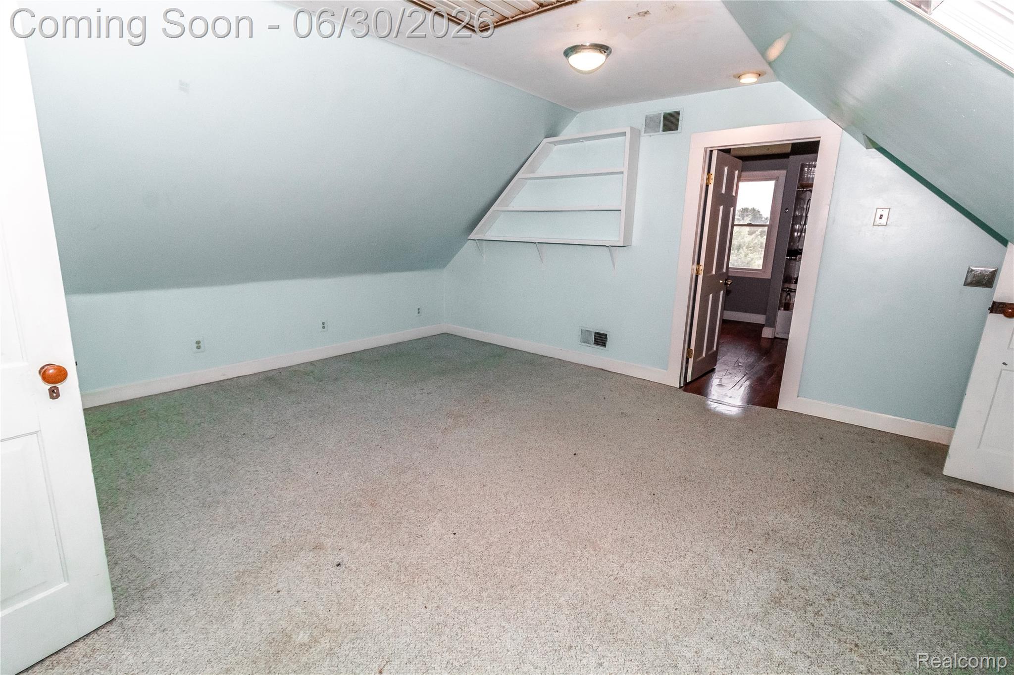 8150 Norman Road Imlay City, MI 48444 - Photo 36 of 58 Room featuring sloped ceilings, light blue painted walls, and light-colored carpeting