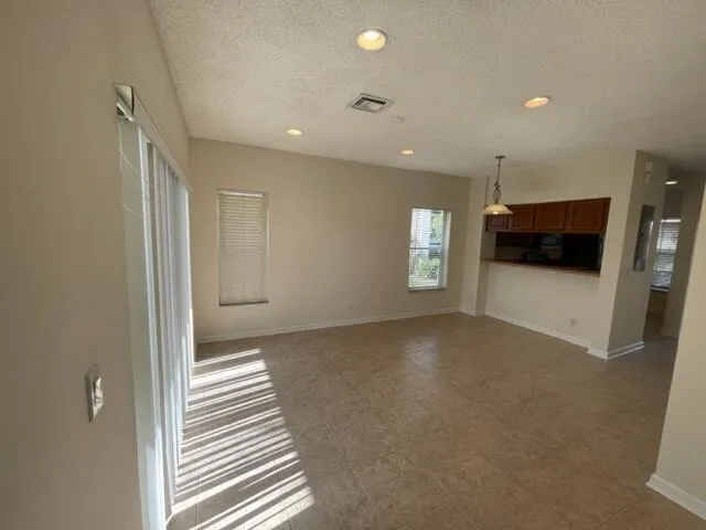 an empty room with windows and pillars in it