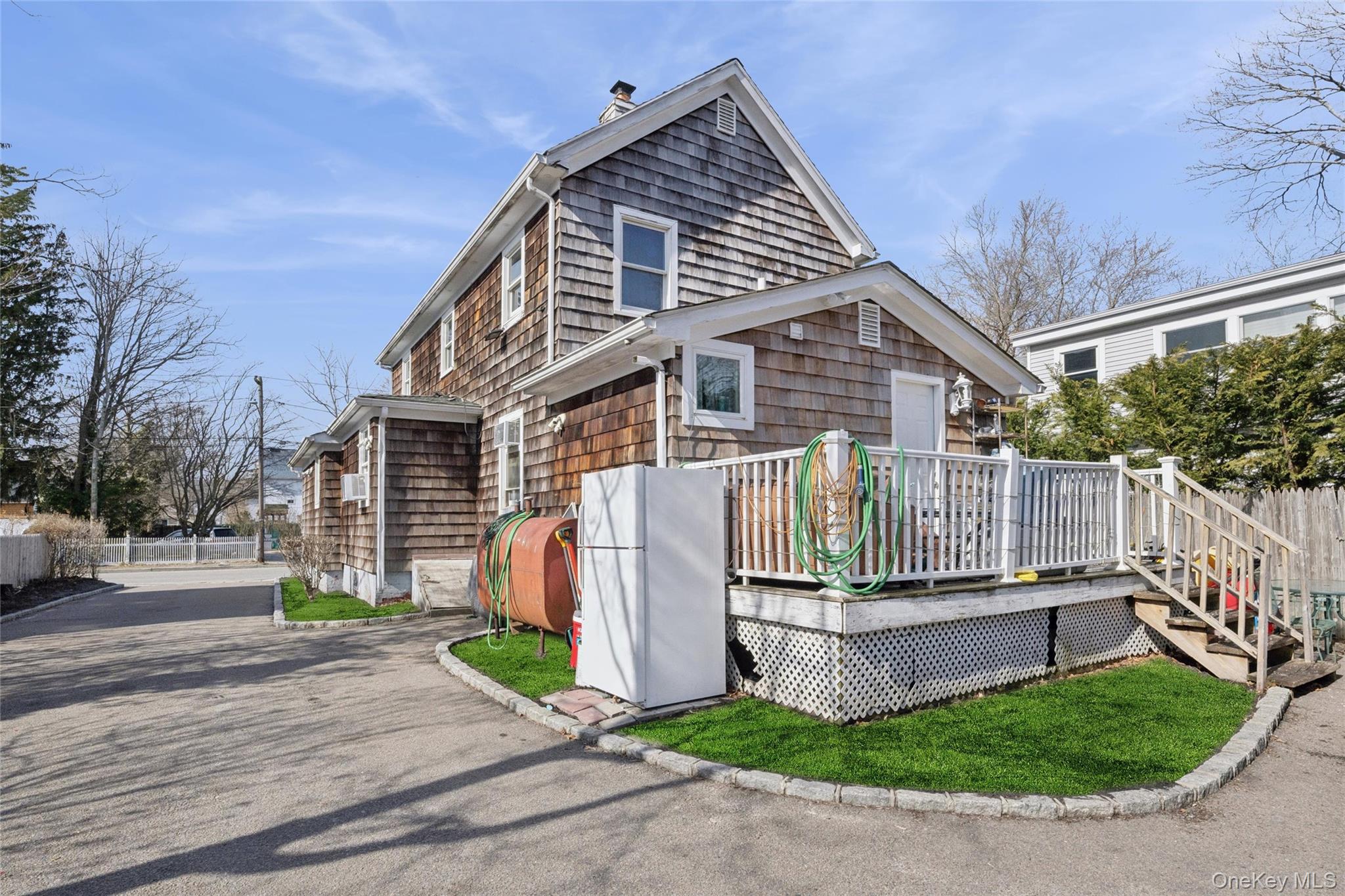 346 Maple Avenue Riverhead, NY 11901 - Photo 11 of 12 a front view of a house with garden