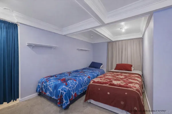 a bedroom with two beds and a night stand