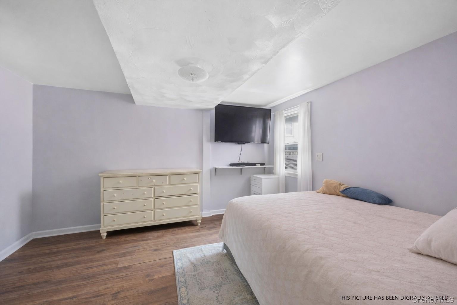 346 Maple Avenue Riverhead, NY 11901 - Photo 6 of 12 a bedroom with a bed and a flat screen tv