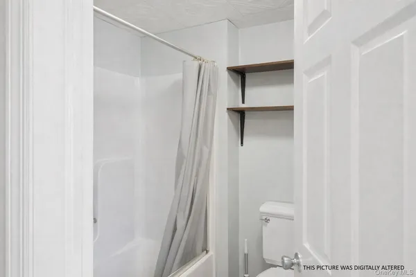 a bathroom with a shower and a glass door