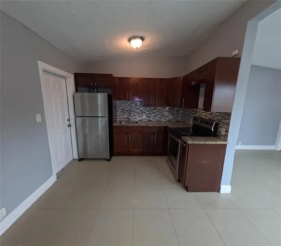 a kitchen with stainless steel appliances a refrigerator and a stove