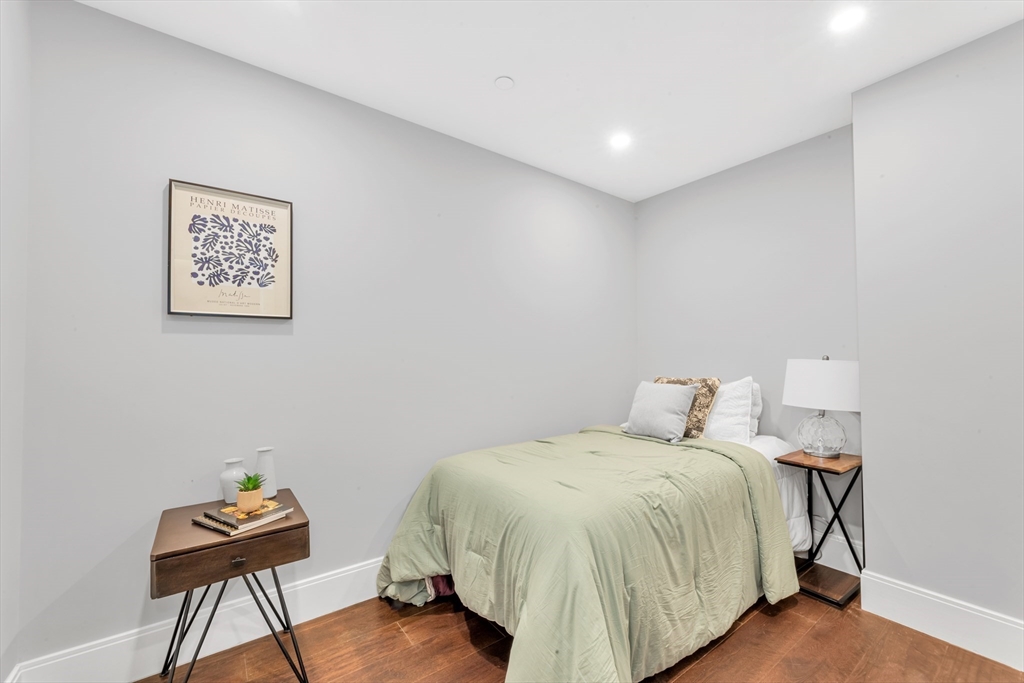 480 West Broadway, Unit 7 Boston, MA 02127 - Photo 14 of 19 a bed room with a bed and a chair