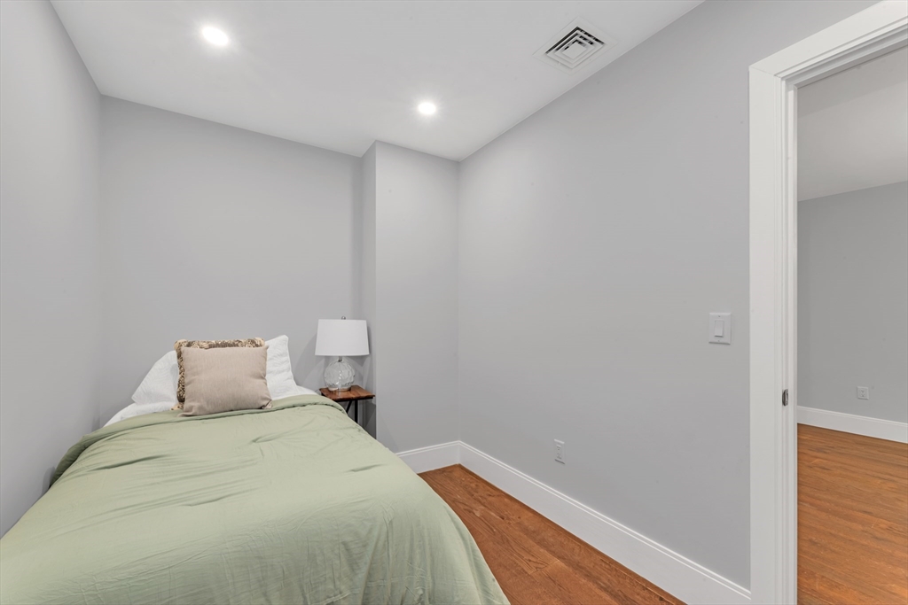 480 West Broadway, Unit 7 Boston, MA 02127 - Photo 15 of 19 a bedroom with a bed and lamp