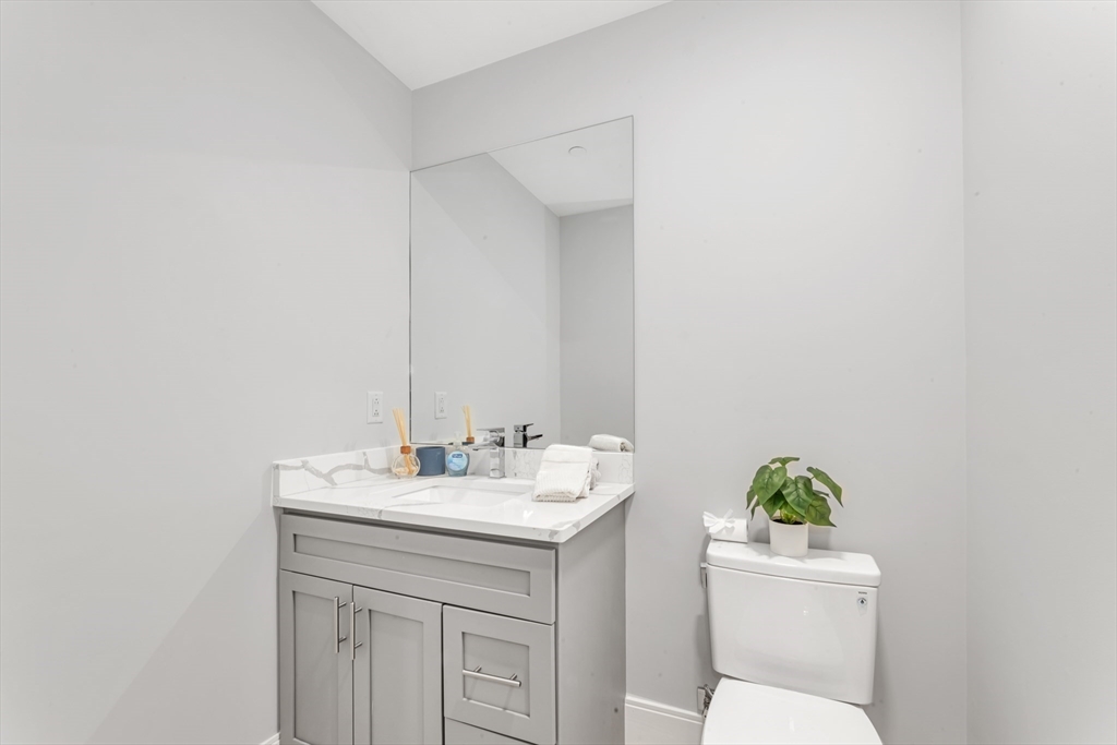 480 West Broadway, Unit 7 Boston, MA 02127 - Photo 6 of 19 a bathroom with a toilet sink and mirror