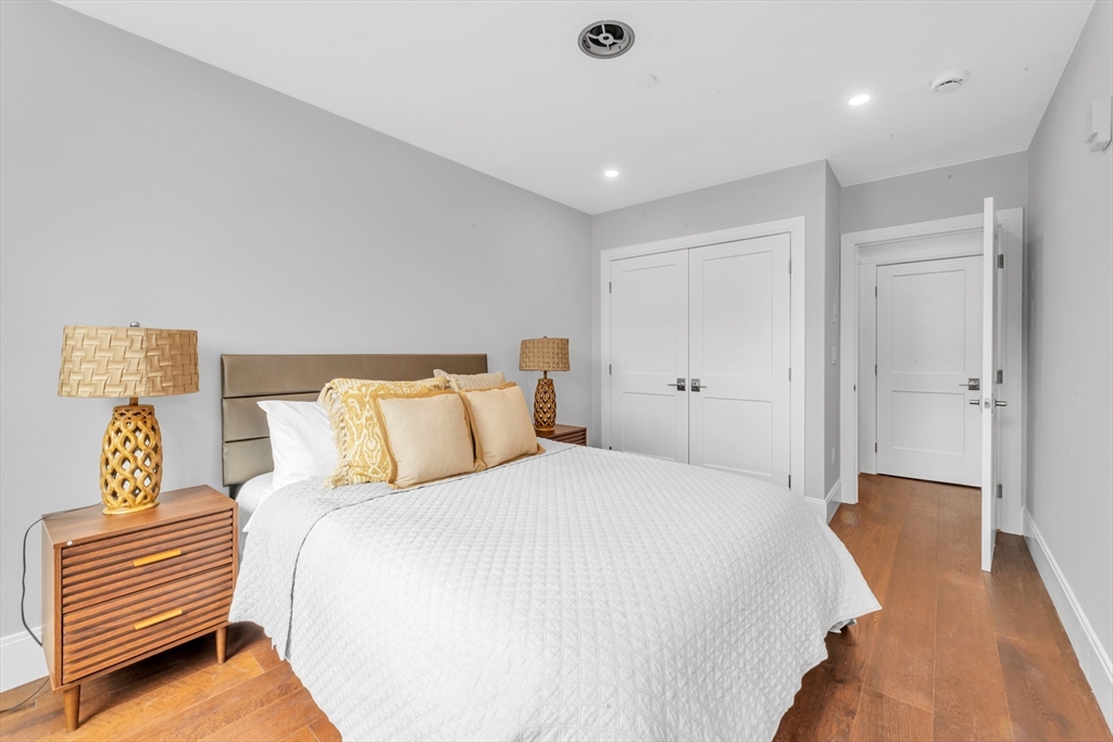 480 West Broadway, Unit 7 Boston, MA 02127 - Photo 10 of 19 a bedroom with a bed and wooden floor