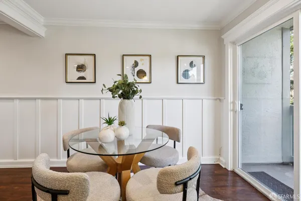 a dining room with furniture and wooden floor
