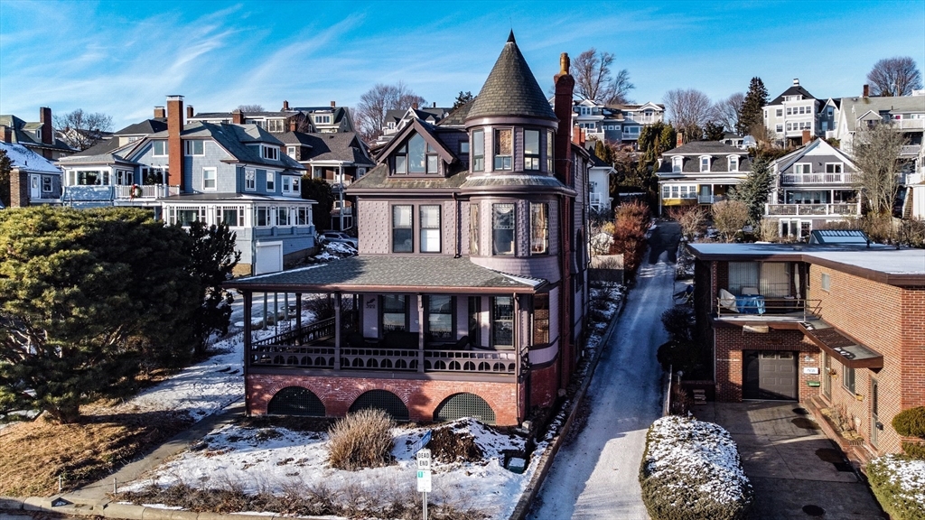 322 Humphrey Street, Unit 1 Swampscott, MA 01907 - Photo 1 of 27 a view of a big yard in front of the house