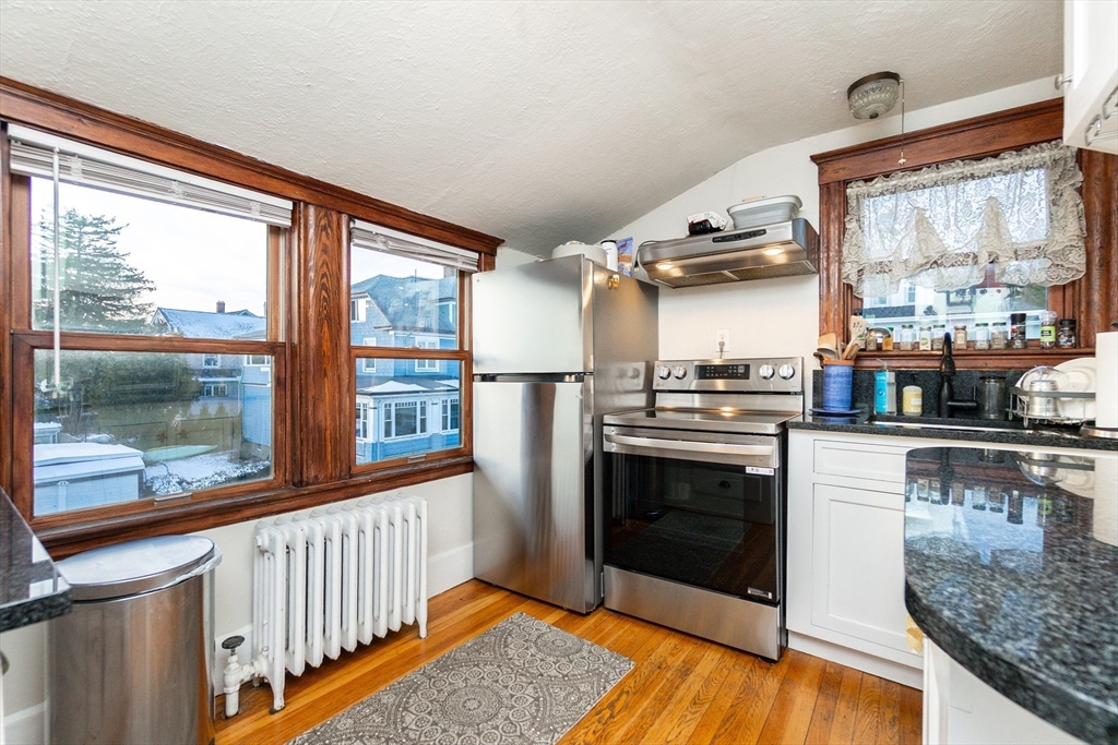 322 Humphrey Street, Unit 1 Swampscott, MA 01907 - Photo 13 of 27 a kitchen with stainless steel appliances granite countertop a stove and a refrigerator