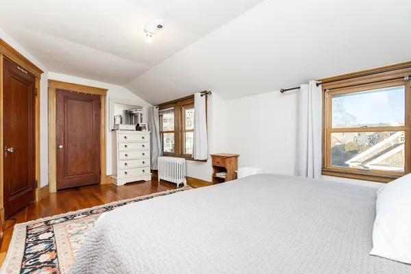 a bedroom with a bed and a large window