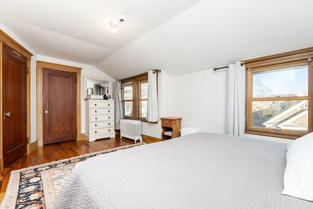 a bedroom with a bed and a large window