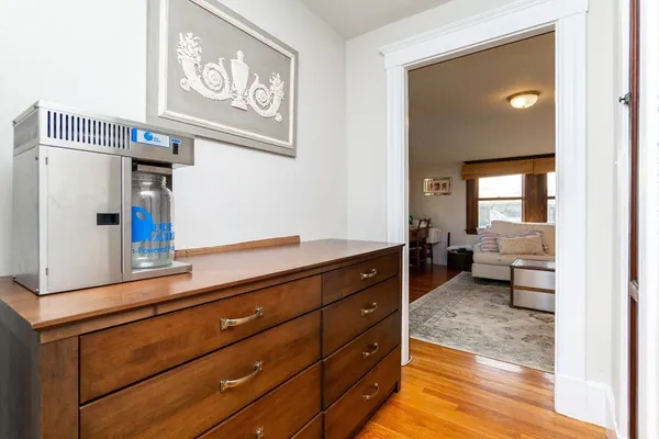 a living room with furniture and a mirror