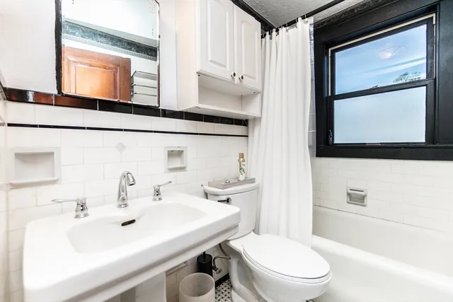 a bathroom with a sink a toilet and mirror