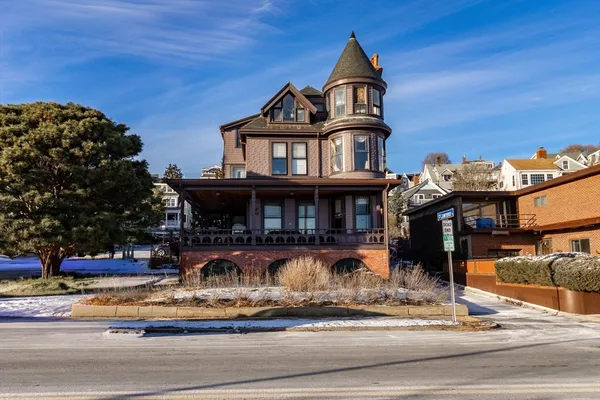 a front view of a house with lots of trees