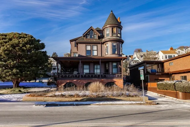 a front view of a house with lots of trees