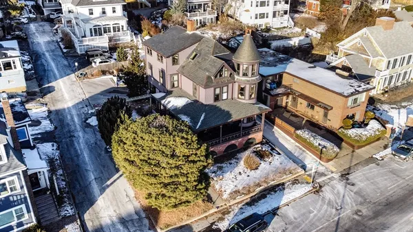 an aerial view of a house with a yard