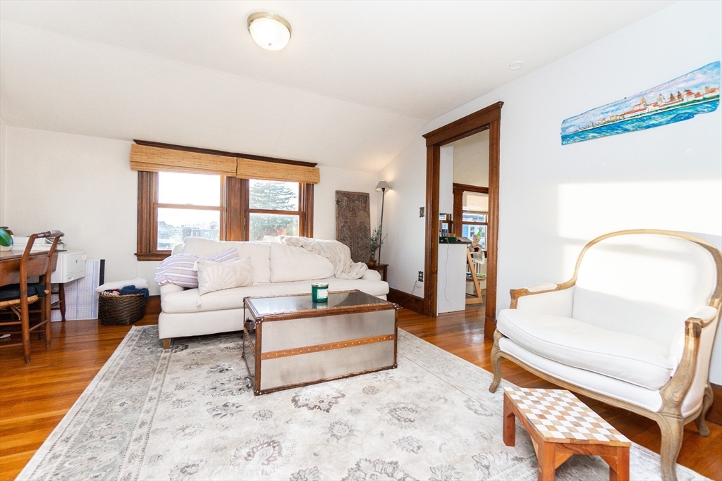 322 Humphrey Street, Unit 1 Swampscott, MA 01907 - Photo 6 of 27 a living room with furniture and a large window