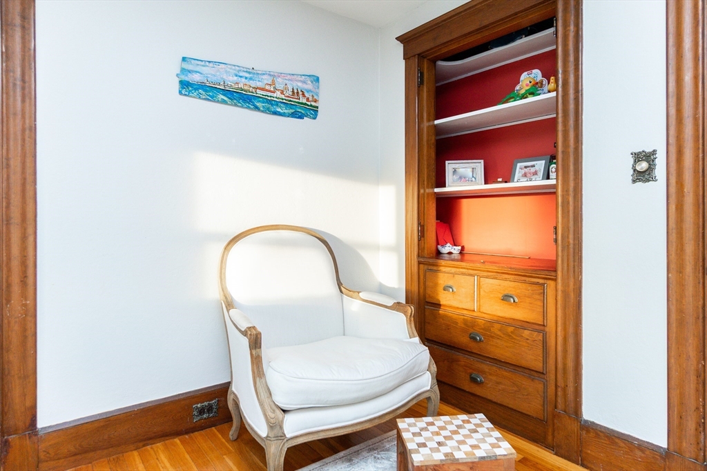 322 Humphrey Street, Unit 1 Swampscott, MA 01907 - Photo 7 of 27 a room with a chair and a window