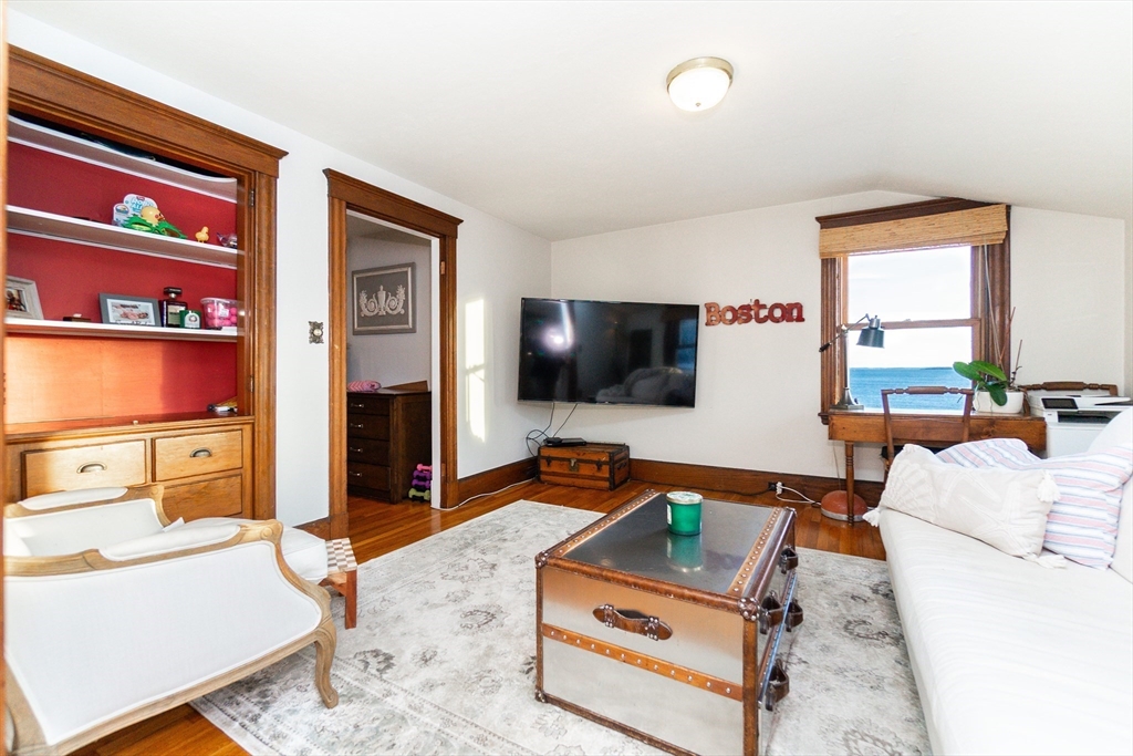 322 Humphrey Street, Unit 1 Swampscott, MA 01907 - Photo 8 of 27 a living room with furniture and a flat screen tv