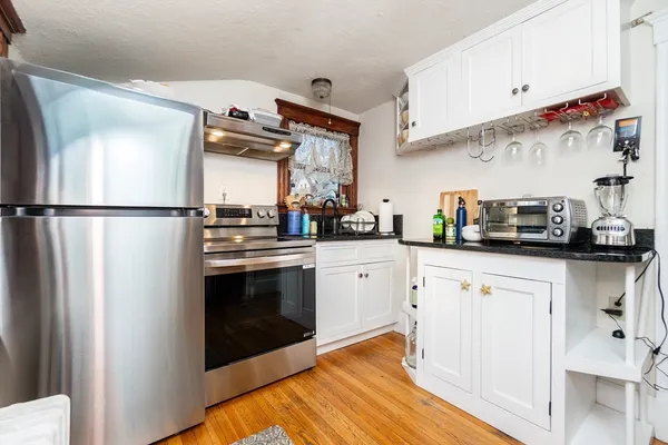 a kitchen with stainless steel appliances a refrigerator sink and cabinets