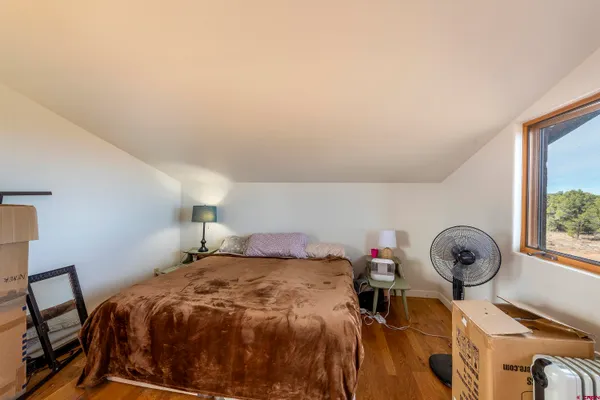a bed sitting in a bedroom next to a window